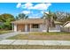 One-story house with attached garage, palm tree, and well-maintained lawn at 5461 Colchester Ave, Spring Hill, FL 34608