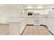 White kitchen with ample counter space and built-in microwave at 5461 Colchester Ave, Spring Hill, FL 34608
