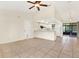 Open living area with tile floors and a ceiling fan at 5461 Colchester Ave, Spring Hill, FL 34608