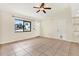 Bright living room featuring tile floors and a ceiling fan at 5461 Colchester Ave, Spring Hill, FL 34608