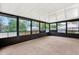 Bright sunroom with large windows and carpeted floor at 5461 Colchester Ave, Spring Hill, FL 34608