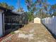 Backyard with screened pool, shed, and privacy fence at 6141 Freeport Dr, Spring Hill, FL 34606