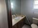Bathroom with single sink vanity, toilet and shower at 6141 Freeport Dr, Spring Hill, FL 34606