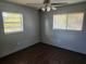 Spacious bedroom with dark laminate flooring and ceiling fan at 6141 Freeport Dr, Spring Hill, FL 34606