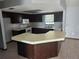 Galley kitchen with dark cabinets and island at 6141 Freeport Dr, Spring Hill, FL 34606