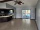 Open living area with kitchen and pool access at 6141 Freeport Dr, Spring Hill, FL 34606