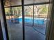 View of refreshing swimming pool with safety fence at 6141 Freeport Dr, Spring Hill, FL 34606