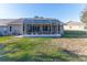 Home's backyard features a screened patio at 7425 Nature Walk Dr, Spring Hill, FL 34606