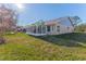 House with grassy backyard and screened patio at 7425 Nature Walk Dr, Spring Hill, FL 34606