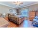 Spacious bedroom with wood flooring and a large window at 7425 Nature Walk Dr, Spring Hill, FL 34606