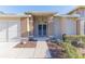 Front entrance with a screened door and walkway at 7425 Nature Walk Dr, Spring Hill, FL 34606