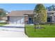 Brick house with two-car garage and nicely landscaped lawn at 7425 Nature Walk Dr, Spring Hill, FL 34606