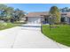 Brick house with a two-car garage and a well-manicured lawn at 7425 Nature Walk Dr, Spring Hill, FL 34606