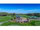 Aerial view of golf course clubhouse, cart storage, and practice area at 7425 Nature Walk Dr, Spring Hill, FL 34606