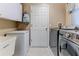 Laundry room with washer, dryer, and extra storage space at 7425 Nature Walk Dr, Spring Hill, FL 34606