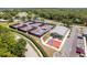 Aerial view of community pickleball and tennis courts with clubhouse at 7425 Nature Walk Dr, Spring Hill, FL 34606