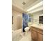 Bathroom with tub, toilet, and wood vanity at 7805 Radcliffe Cir # 7805, Port Richey, FL 34668