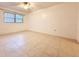 Bright bedroom featuring tile floors and ceiling fan at 7805 Radcliffe Cir # 7805, Port Richey, FL 34668