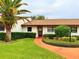 Well-maintained house with a landscaped front yard and walkway at 7805 Radcliffe Cir # 7805, Port Richey, FL 34668