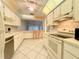 Well-equipped kitchen with white cabinets and tile floors at 7805 Radcliffe Cir # 7805, Port Richey, FL 34668