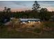 Single-story home with landscaped yard, viewed at dusk at 7815 Tanglewood Dr, New Port Richey, FL 34654