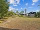 Spacious backyard featuring a swing set and partial home view at 7815 Tanglewood Dr, New Port Richey, FL 34654