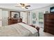 Bright bedroom with sliding glass doors, ceiling fan, and ample closet space at 7815 Tanglewood Dr, New Port Richey, FL 34654