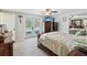Main bedroom with double doors leading to the backyard, ceiling fan, and dresser at 7815 Tanglewood Dr, New Port Richey, FL 34654