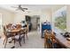 Dining room with wooden table and chairs, and view of the kitchen at 7815 Tanglewood Dr, New Port Richey, FL 34654