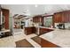 Spacious kitchen featuring granite countertops, stainless steel appliances, and dark wood cabinets at 7815 Tanglewood Dr, New Port Richey, FL 34654