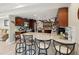 Kitchen with granite counters, dark wood cabinets, and breakfast bar at 7815 Tanglewood Dr, New Port Richey, FL 34654