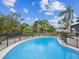 Refreshing kidney-shaped pool, fully fenced, ideal for relaxation and recreation at 7815 Tanglewood Dr, New Port Richey, FL 34654