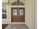 Double front doors with decorative glass panels and a tiled entryway at 8730 Torchwood Dr, Trinity, FL 34655