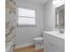 Updated bathroom with marble-look tile and modern vanity at 9126 Lester Ln, Spring Hill, FL 34606