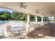 Covered patio area with tables near pool at 10008 Zennia Ln, Parrish, FL 34219