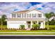 Two-story house with a white exterior, brown roof, and landscaping at 10017 Zennia Ln, Parrish, FL 34219