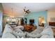 Living room with sectional sofa and vaulted ceiling at 10030 Brookdale Dr, New Port Richey, FL 34655