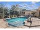 Screened pool area with fountain and lounge chairs at 10124 Southern Breeze Ct, Weeki Wachee, FL 34613