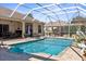 Large screened pool with patio furniture and beautiful landscaping at 10124 Southern Breeze Ct, Weeki Wachee, FL 34613