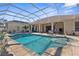 Spacious screened pool and patio with seating area at 10124 Southern Breeze Ct, Weeki Wachee, FL 34613