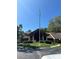 Community clubhouse with a flagpole and landscaping at 10736 Fiddlesticks Ct, New Port Richey, FL 34654