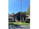 Community clubhouse with a flagpole and landscaping at 10736 Fiddlesticks Ct, New Port Richey, FL 34654