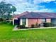 Red-sided villa with a well-maintained lawn and walkway at 10736 Fiddlesticks Ct, New Port Richey, FL 34654