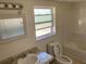 Bathroom with tub, toilet, and sink at 10929 Premier Ave, Port Richey, FL 34668