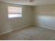 Spacious bedroom with neutral colored walls and carpet at 10929 Premier Ave, Port Richey, FL 34668