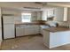 Kitchen features white cabinets, and an island at 10929 Premier Ave, Port Richey, FL 34668