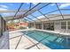 Large, rectangular pool with a covered patio at 11169 Jackdaw Rd, Weeki Wachee, FL 34614