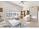 Living room with large window, comfy seating, and a white coffee table at 11271 Frigate Bird Ave, Weeki Wachee, FL 34613