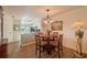 Dining area with wood floors and a view into the living room at 11445 Orleans Ln, Port Richey, FL 34668