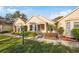 Exterior view of a charming villa with a manicured lawn at 11445 Orleans Ln, Port Richey, FL 34668